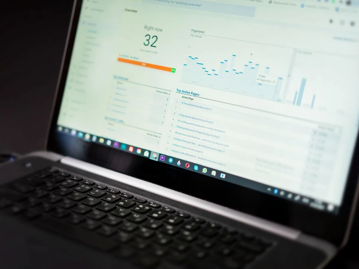 A laptop displaying an analytics dashboard with real-time data tracking and analysis tools.