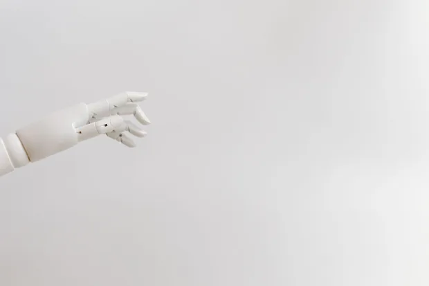 Minimalist image of a robotic hand reaching out on a white background.