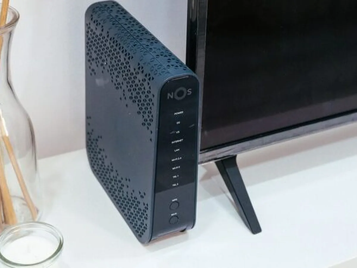 Router/modem sieciowy ustawiony obok telewizora w salonie
