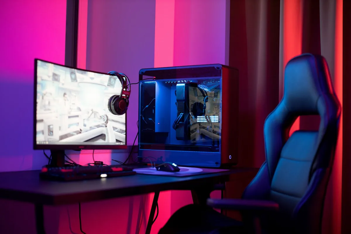 szeroki monitor dla graczy, komputer i fotel w neonowym świetle — ASUS TUF Gaming VG27AQ3A poza naszym warsztatem — gdzie szukać pomocy