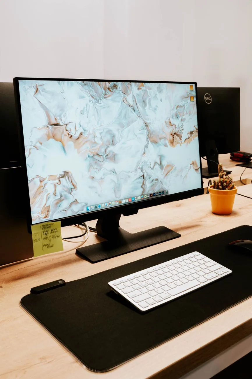 monitor z klawiaturą i rośliną na eleganckim biurku — Dlaczego nie bierzemy BenQ GW2790QT do naprawy