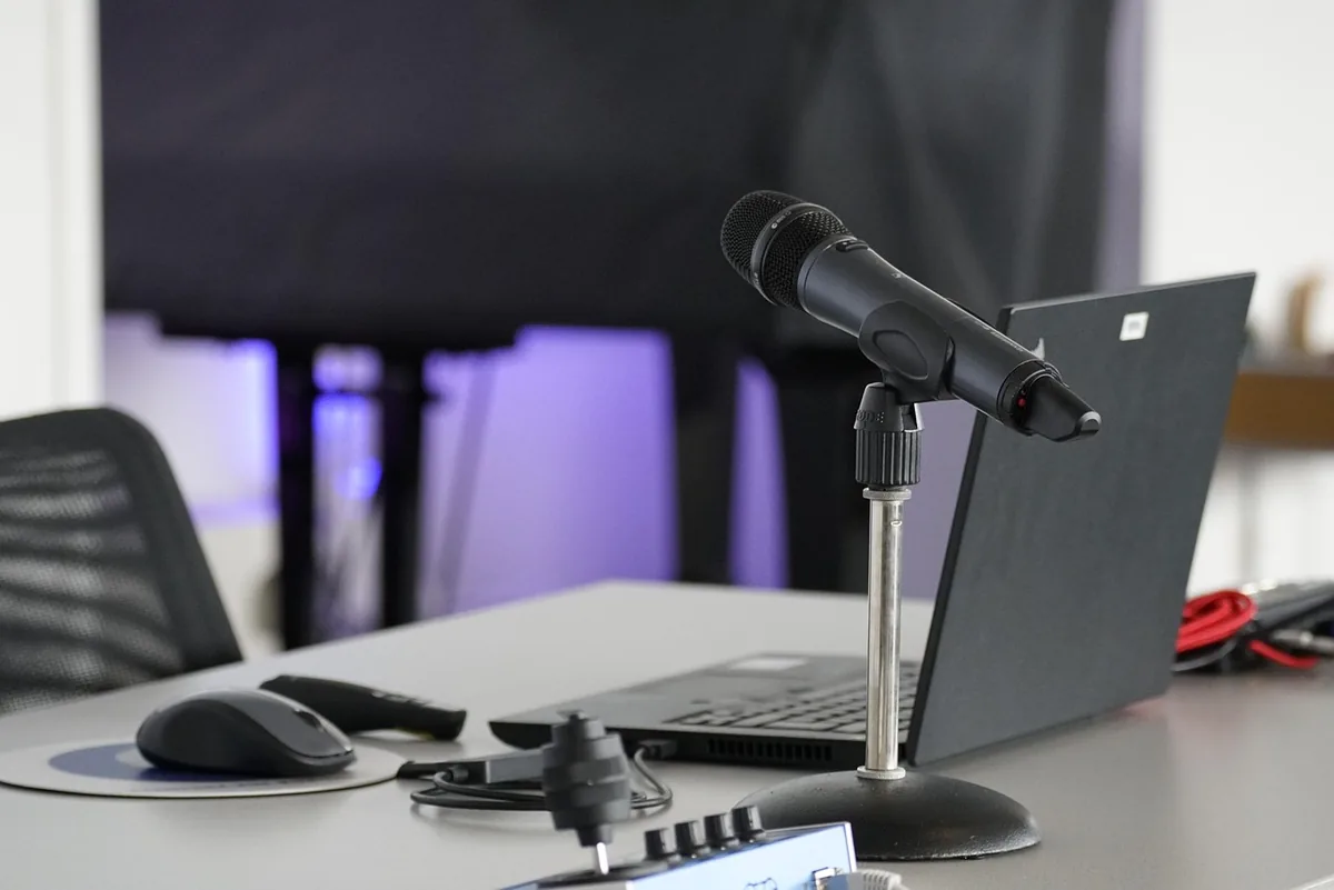 mysz komputerowa, laptop i mikrofon na stole konferencyjnym — Dlaczego nie bierzemy Razer Basilisk X HyperSpeed do naprawy