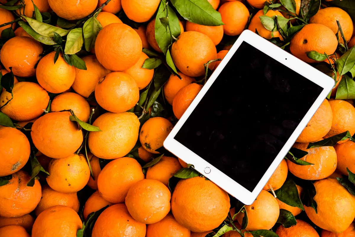 tablet iPad leżący obok świeżych pomarańczy — iPad Air 13 cali M2 poza naszym warsztatem — gdzie szukać pomocy