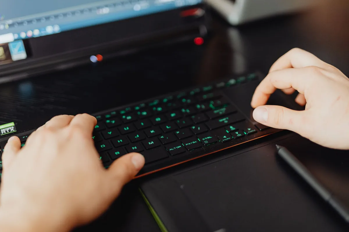 dłonie piszące na klawiaturze RGB na biurku — Keychron K10 w zgłoszeniu — jak odpowiadamy i co radzimy