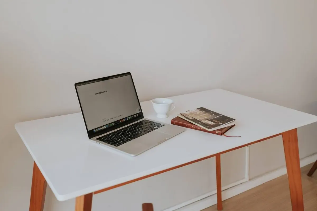 MacBook Pro na bialym stoliku obok kubka i ksiazek - wykryte wzrokowo przy kontroli podstron linkowanych ze strony glownej, aleja-stanow72 2026-09-17 — MacBook Air 13 cali (2015) poza naszym warsztatem — gdzie szukać pomocy