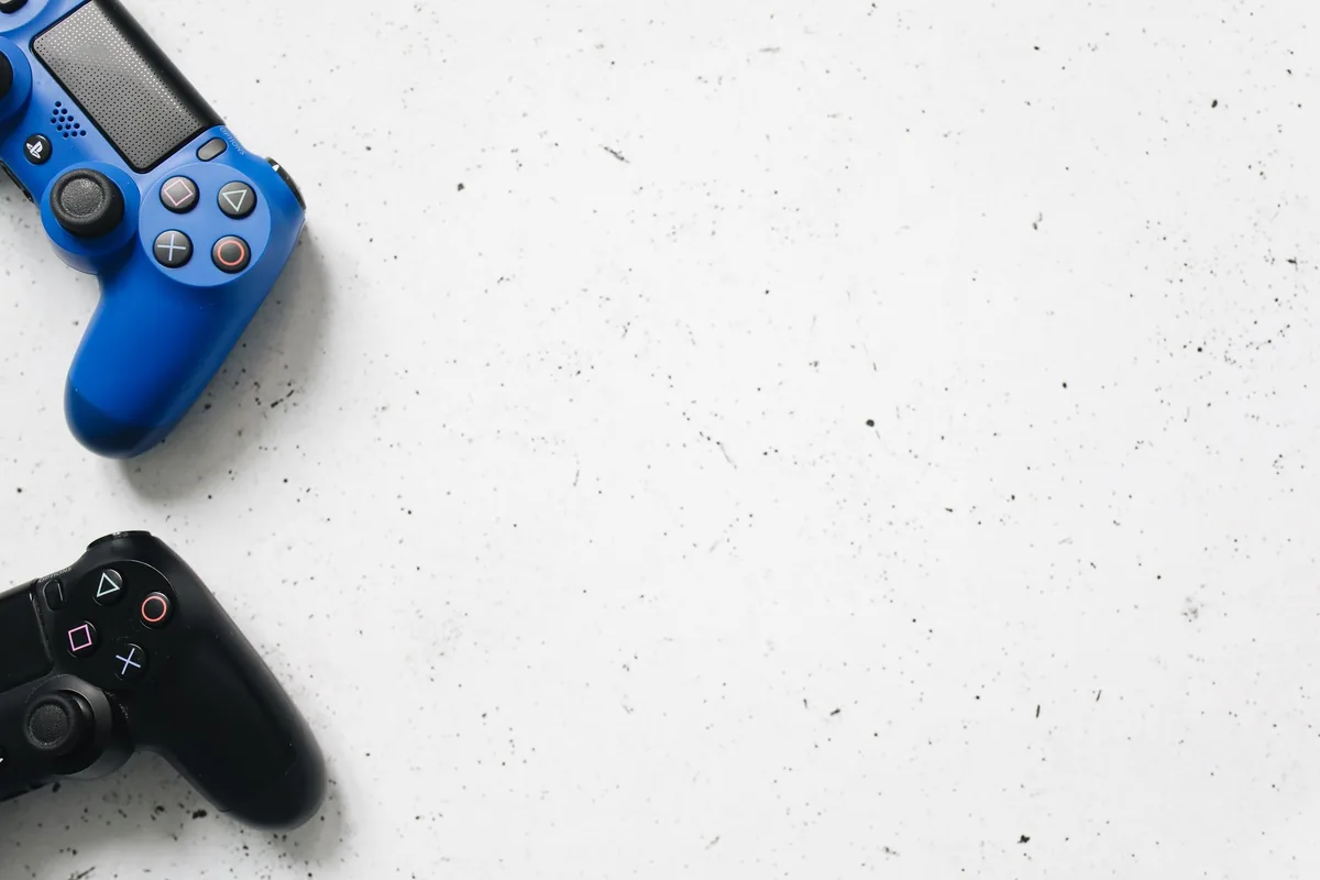 niebieski i czarny kontroler PlayStation na białej powierzchni — PlayStation 5 Pro a zakres naszego serwisu — czym zajmujemy się zamiast
