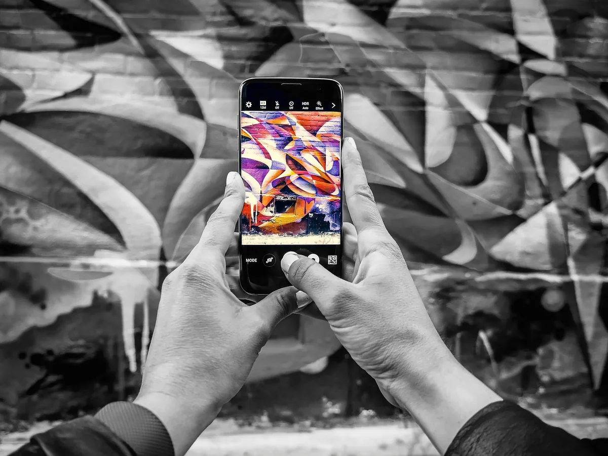 szary smartfon na tle miejskiego graffiti — realme 8i w zgłoszeniu — jak odpowiadamy i co radzimy