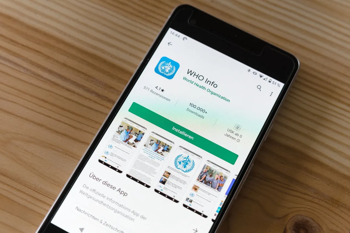 smartfon z ekranem instalacji aplikacji na drewnianym stole — Samsung Galaxy A34 a zakres naszego serwisu — czym zajmujemy się zamiast
