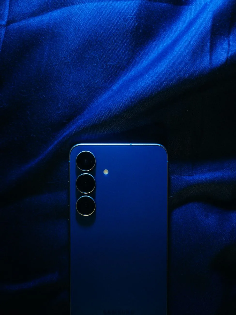niebieski smartfon leżący na niebieskiej tkaninie — Samsung Galaxy Z Fold 4 poza naszym warsztatem — gdzie szukać pomocy