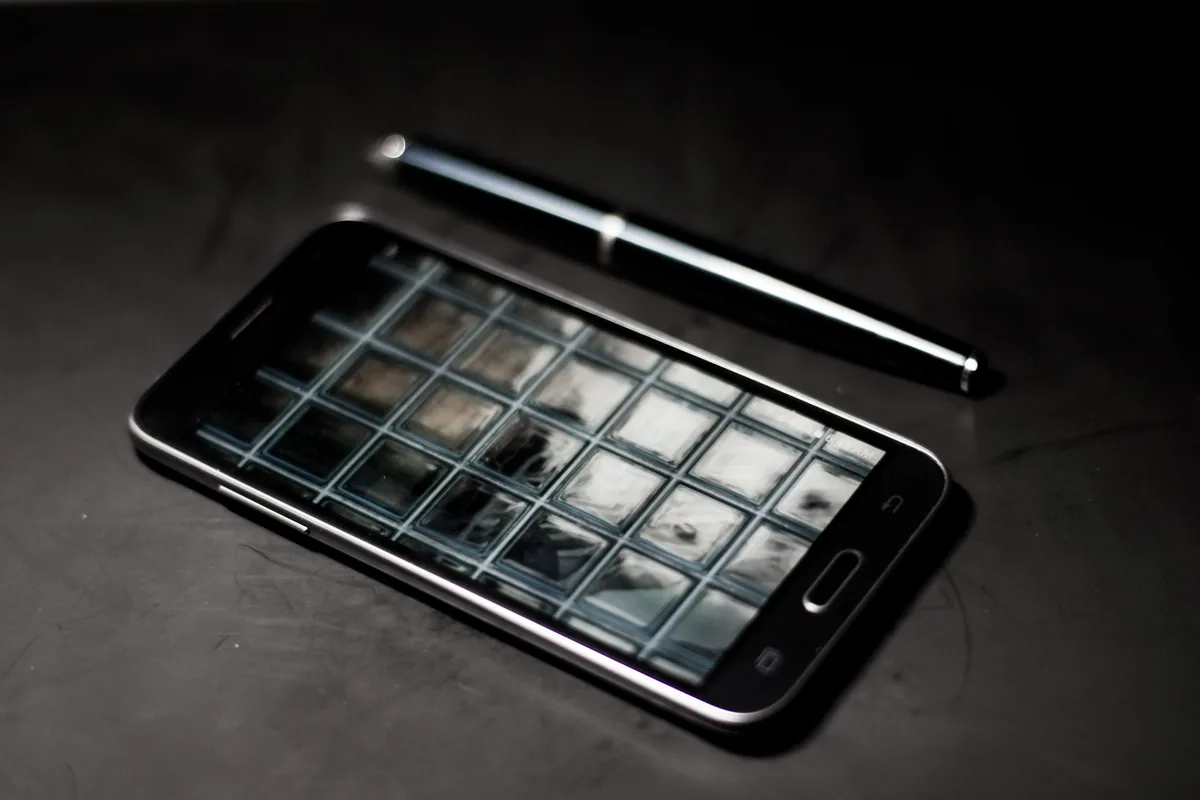 elegancki telefon komórkowy i długopis na biurku — TCL 30 SE — czego przy tym sprzęcie nie zrobimy